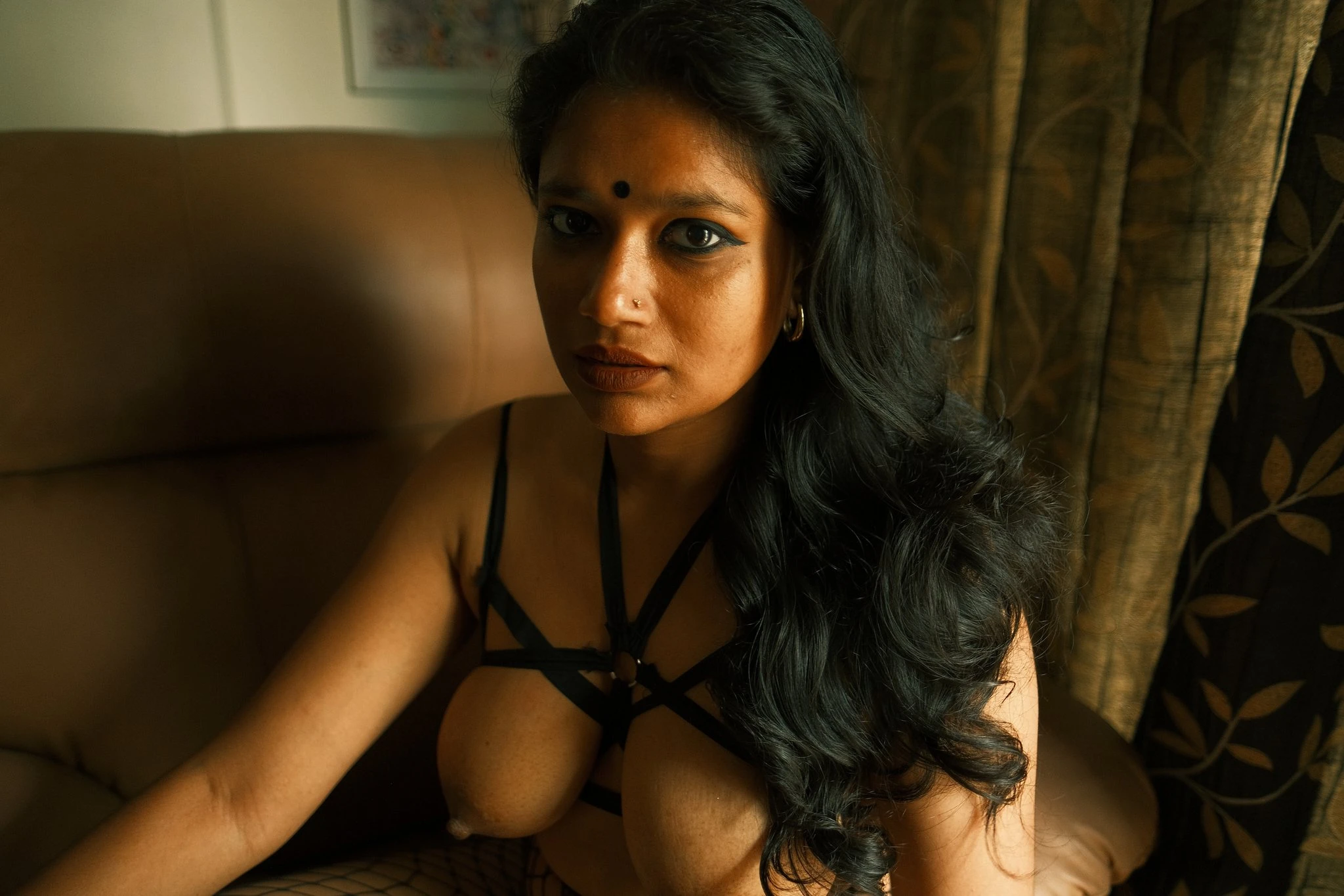 Bangladeshi MILF shows her big tits in a rope shaped bra and posing on a couch