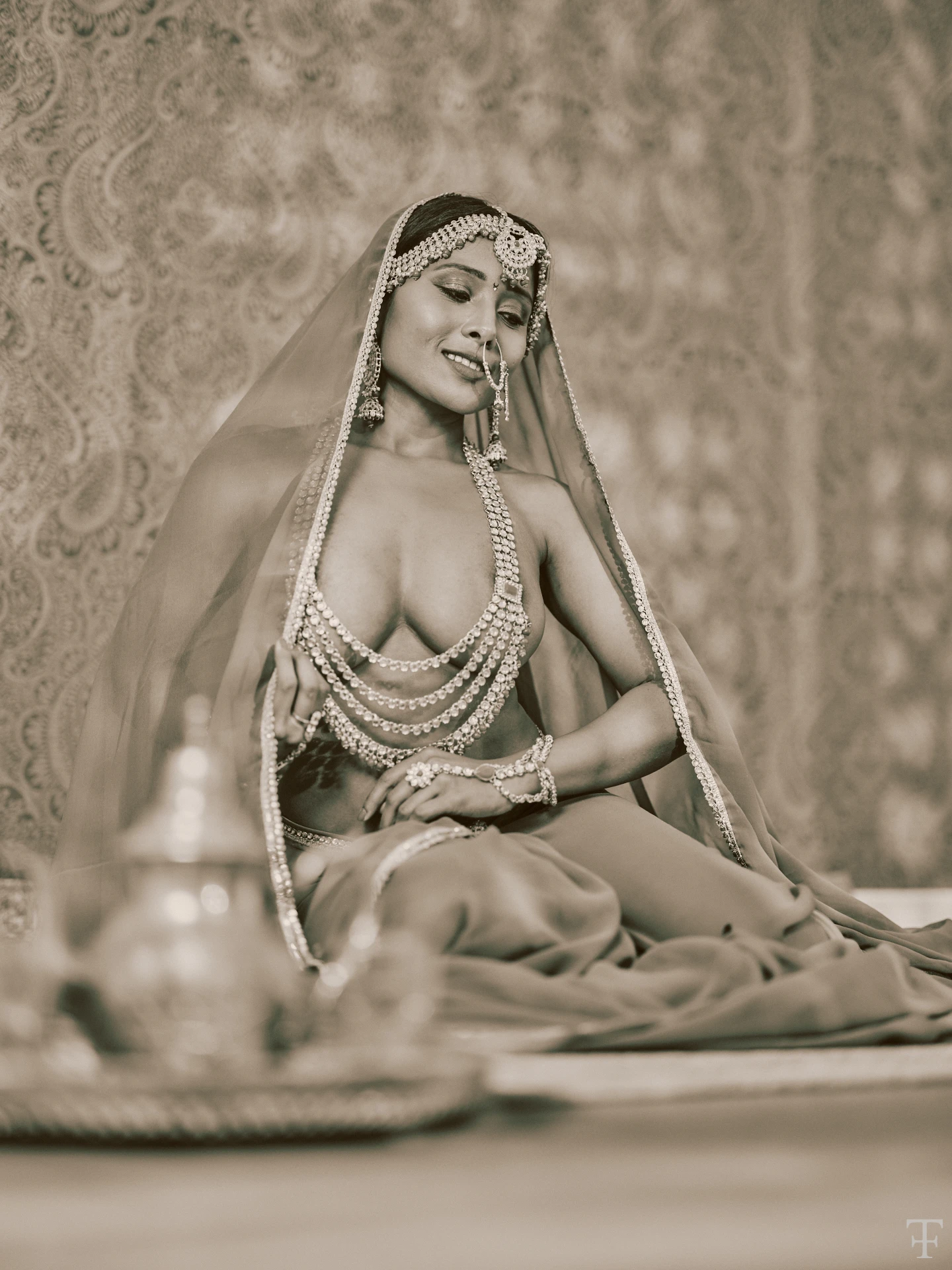 Desi model posing topless wearing large chain and jewels and hiding her big boobs while wearing a veil on her head