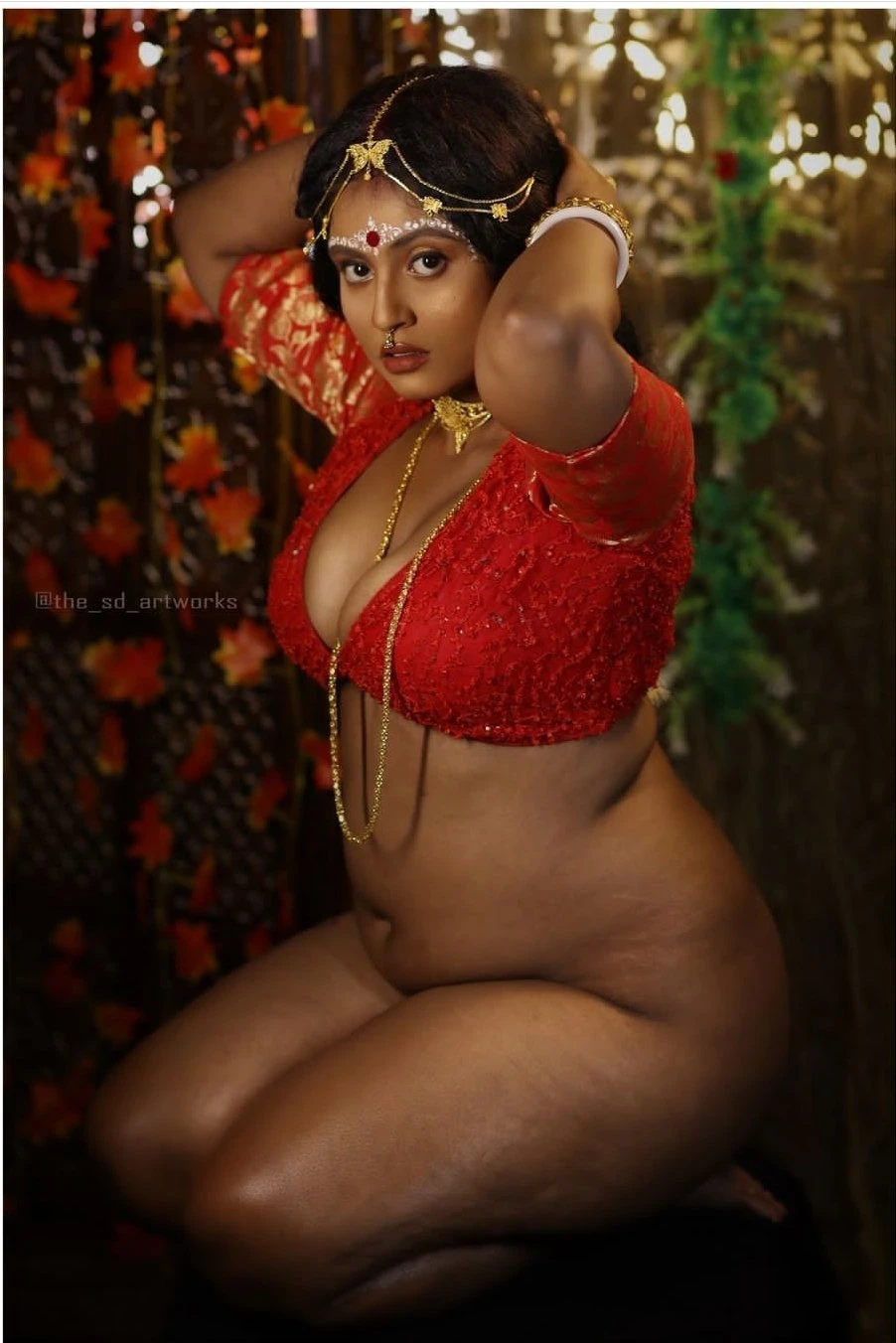 Sensational Desi MILF in bridal makeup and jewels kneeling without wearing anything underneath her braless red blouse