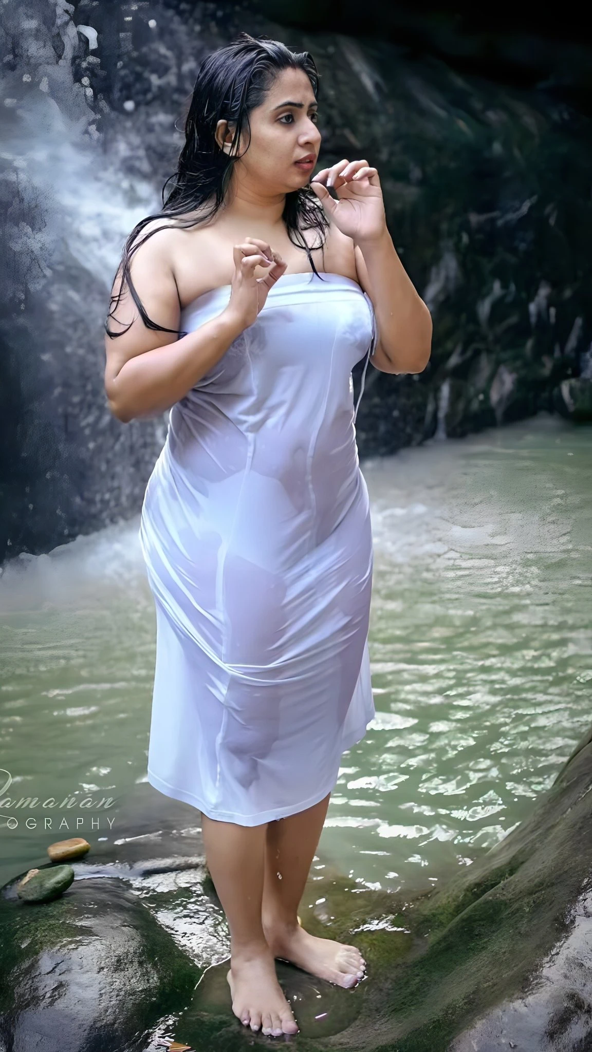 Ravishing Desi MILF in a wet white transparent petticoat and showing her boobs through it near a waterfalls
