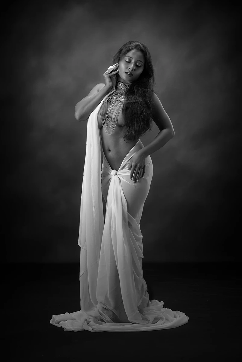 Desi model posing topless wearing jewels and hiding her big boobs while covering herself with a white saree