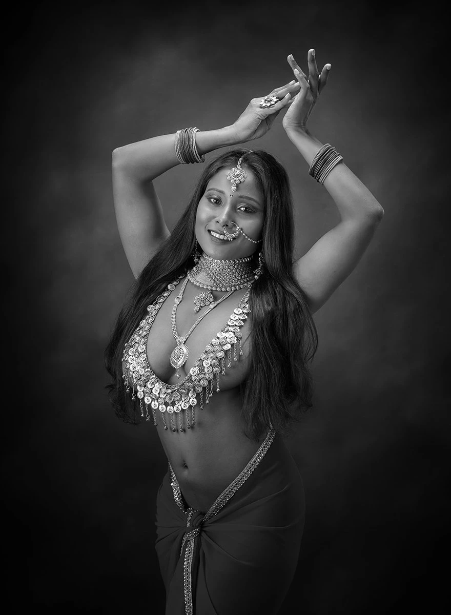 Desi model posing with raised hands and being topless wearing jewellery and hiding her big tits with the large necklace