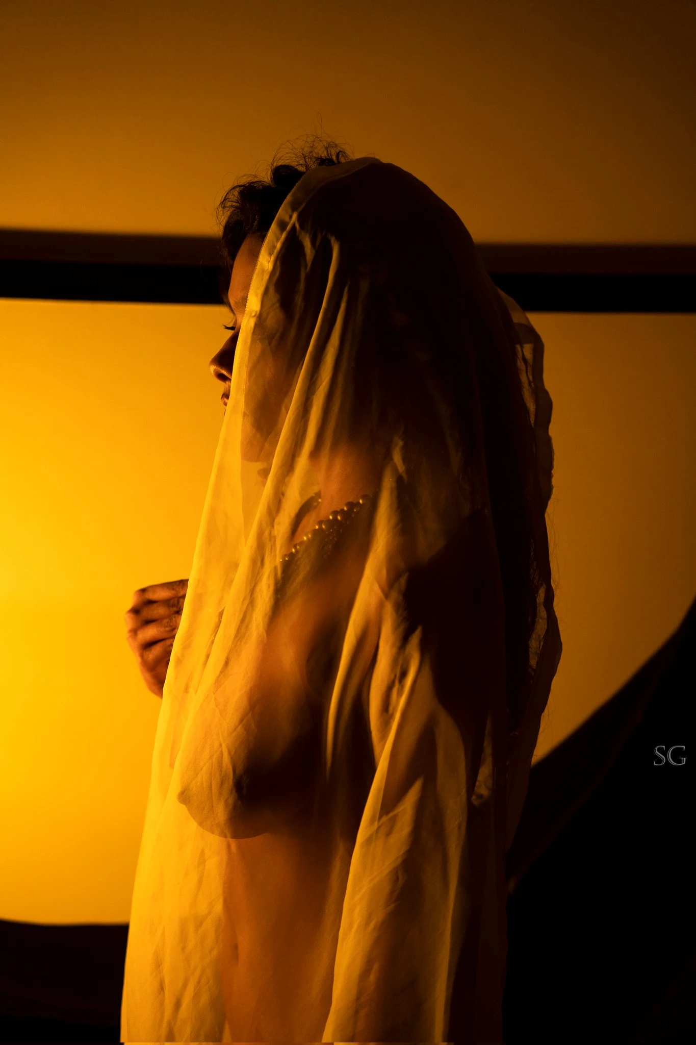 Desi MILF model shows her jugs wearing just a thin braless yellow saree