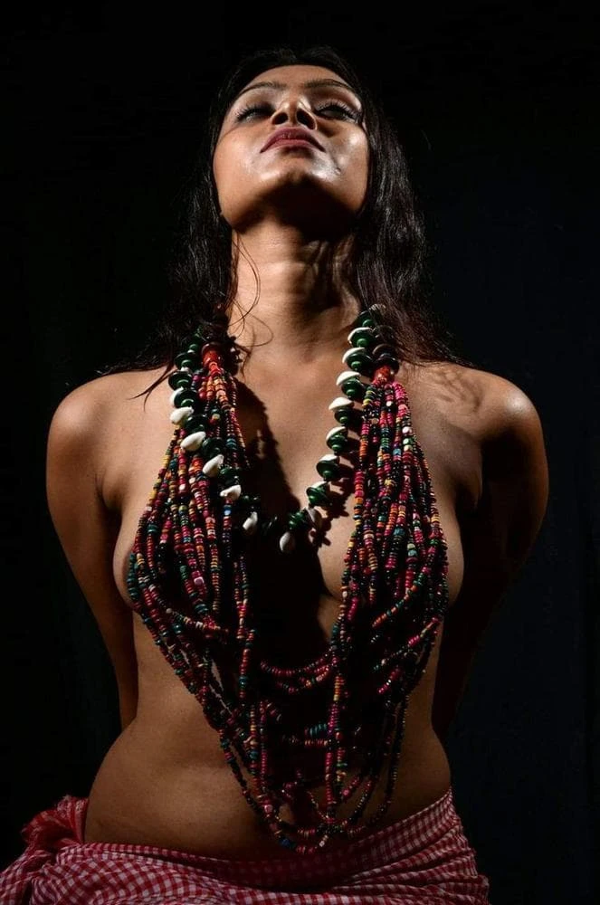Desi model posing almost topless and hiding her boobs with large bead necklaces