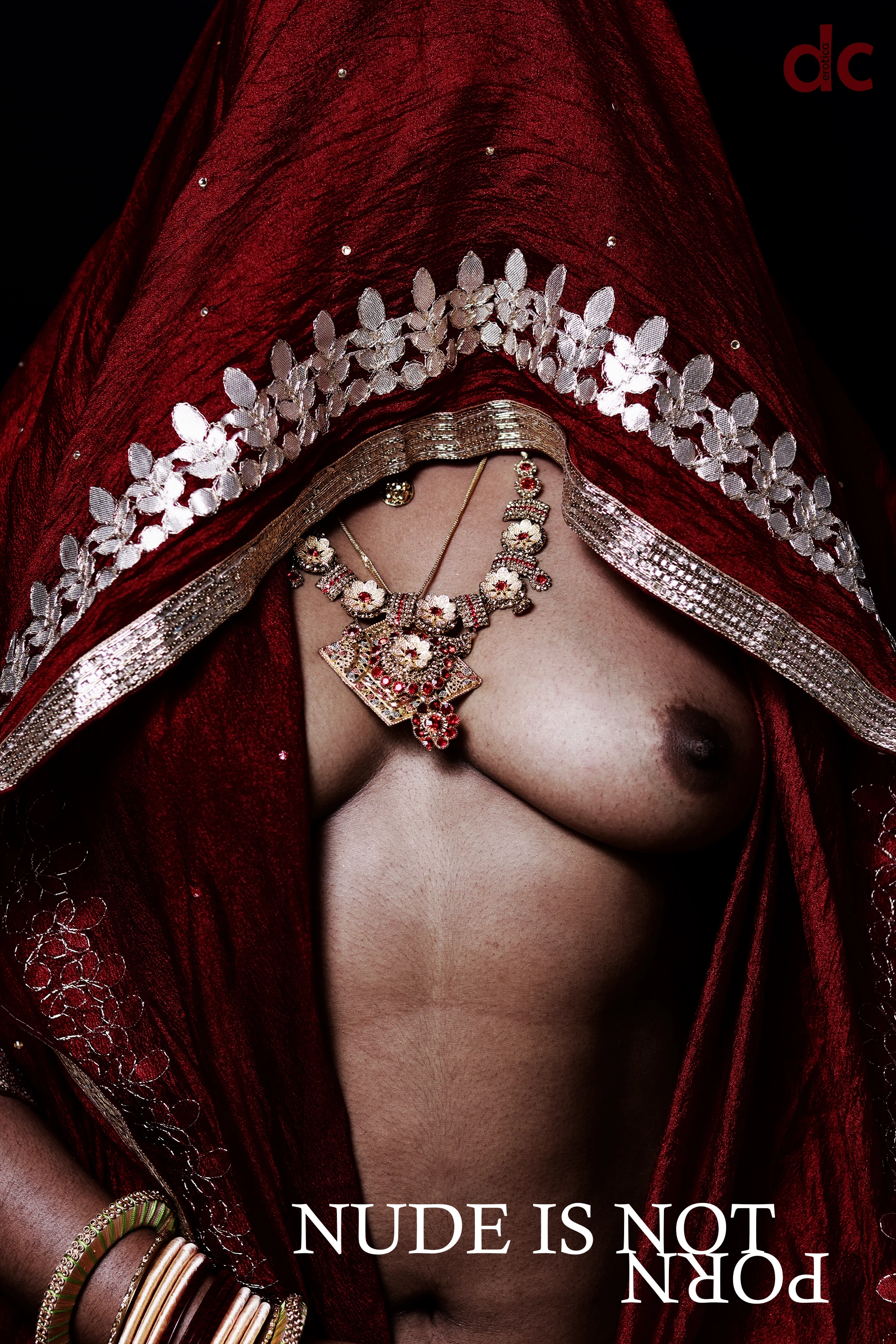 Desi MILF wearing large necklace shows her topless boobies and covering her head and face with a braless maroon saree