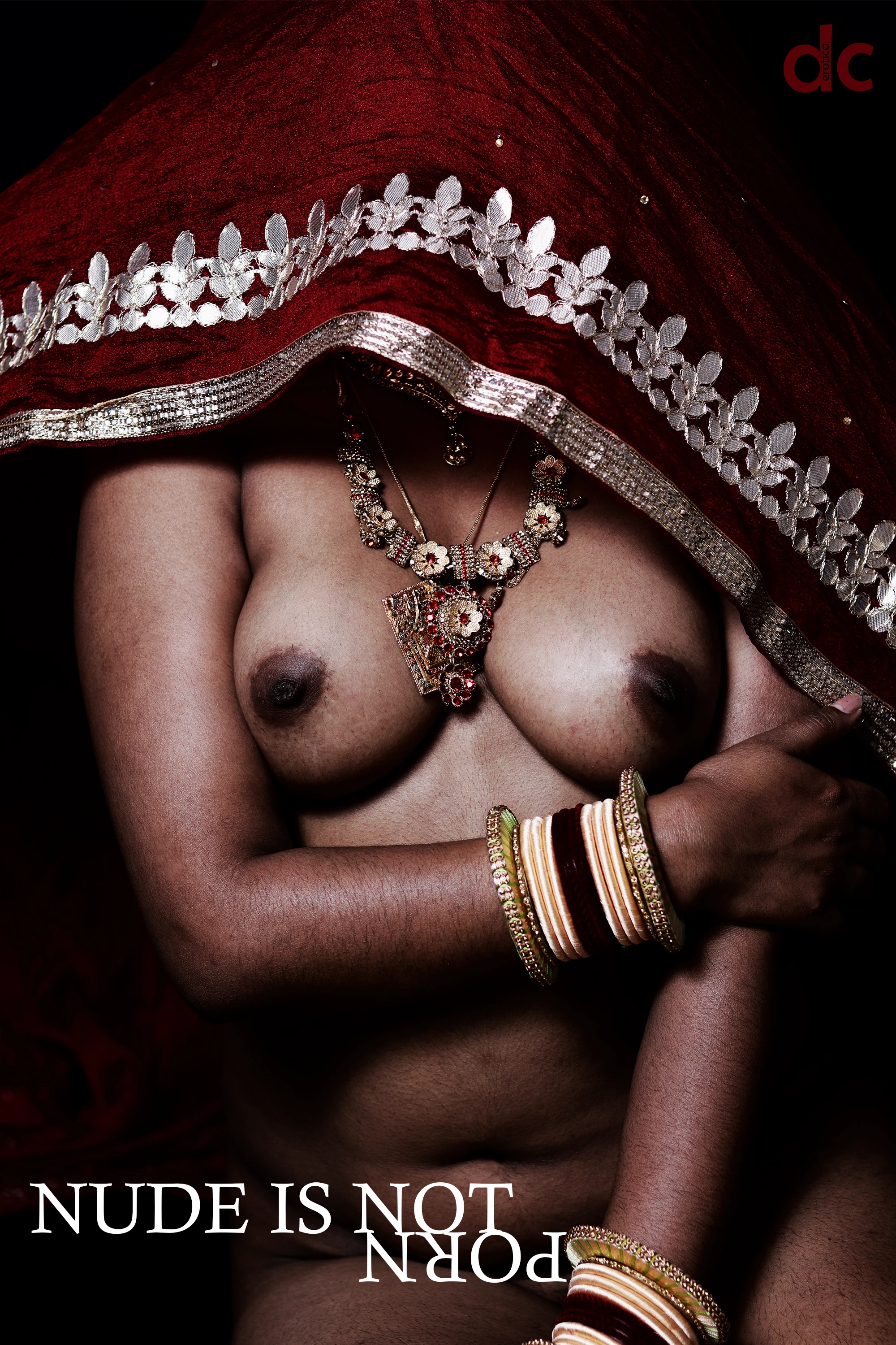Desi MILF wearing large necklace shows her topless boobs and covering her head and face with a braless maroon saree