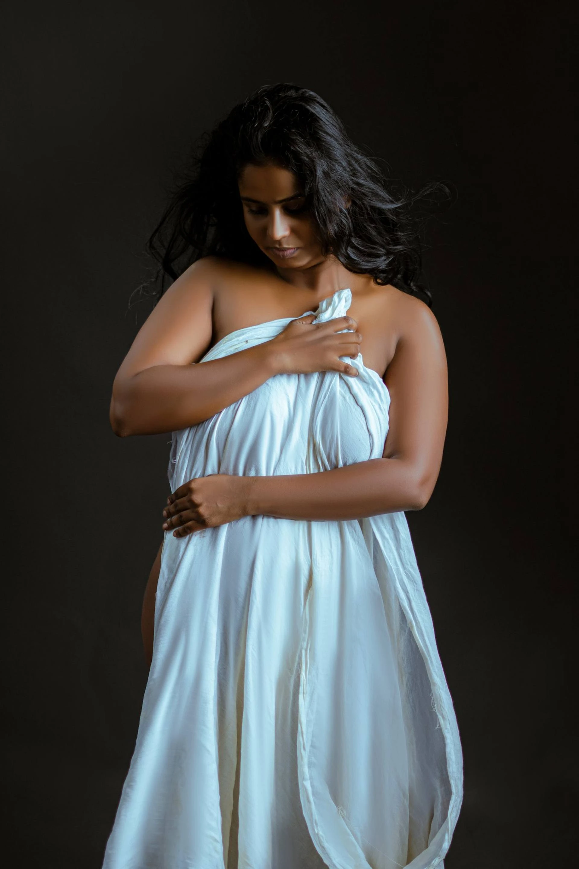Desi MILF hiding her naked self with a white sheet covering the front of her