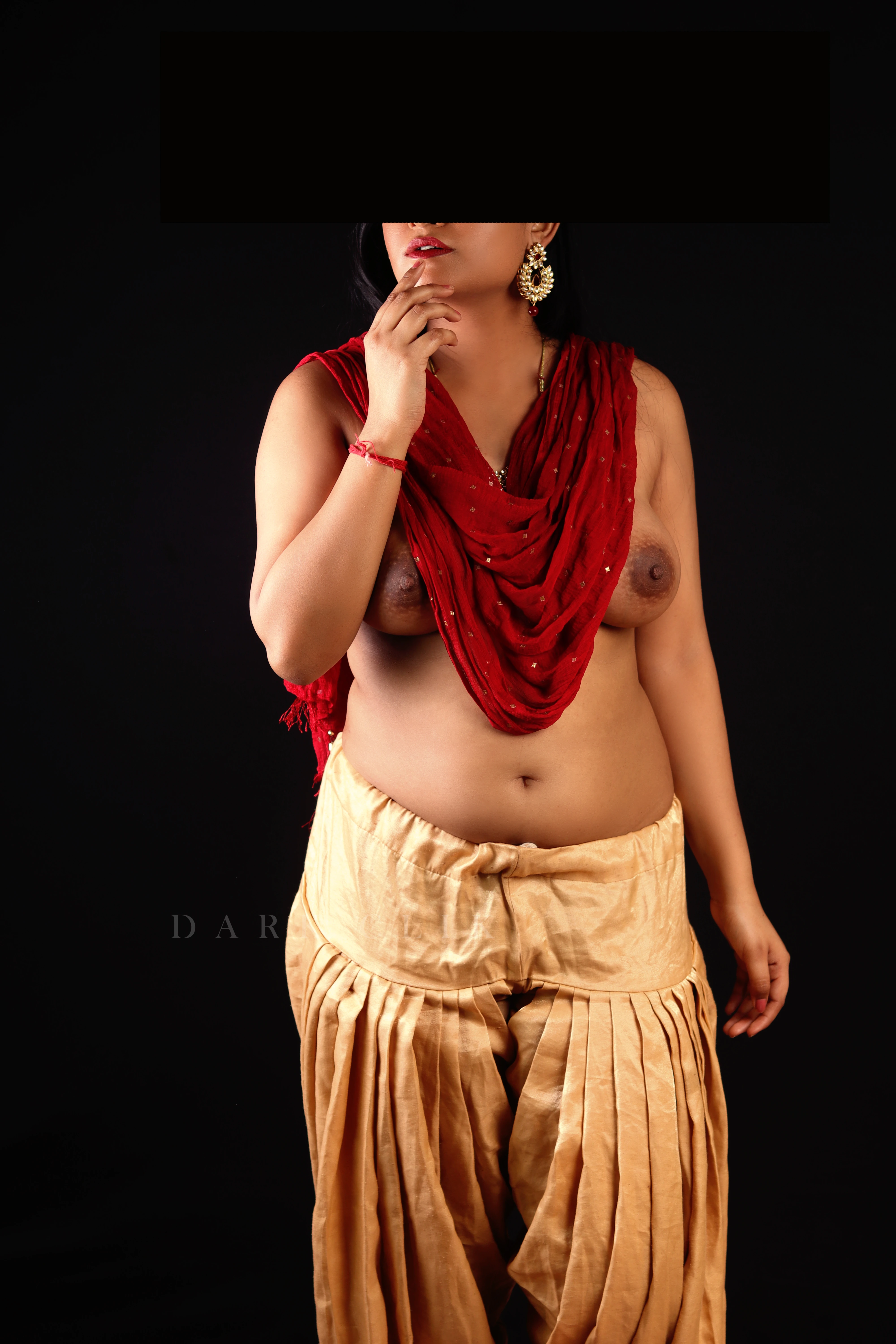 Desi MILF model wearing red cloth and gold pants and shows her boobs