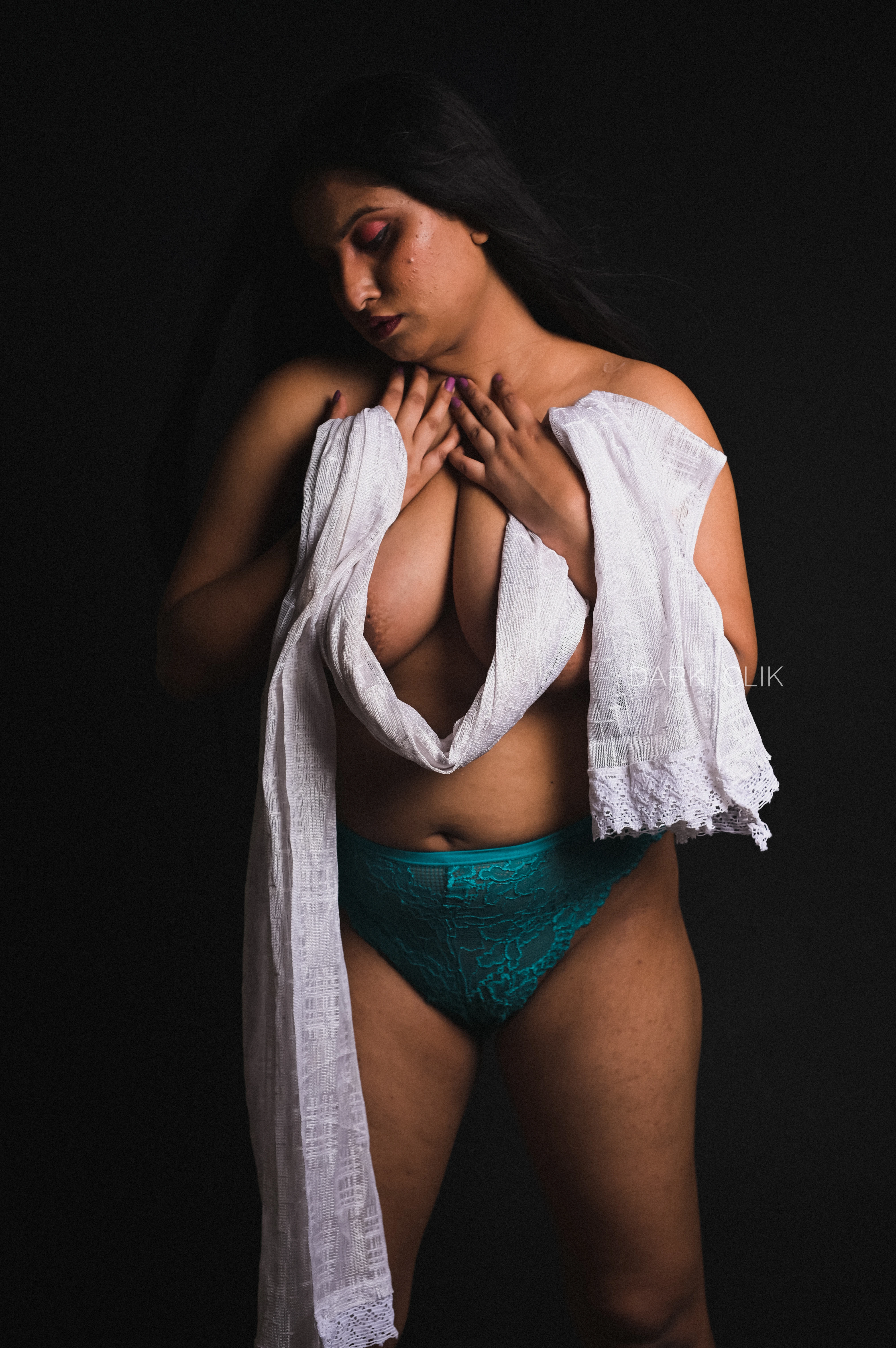 Desi MILF model covering her topless big tits with a white cloth and posing in green panties