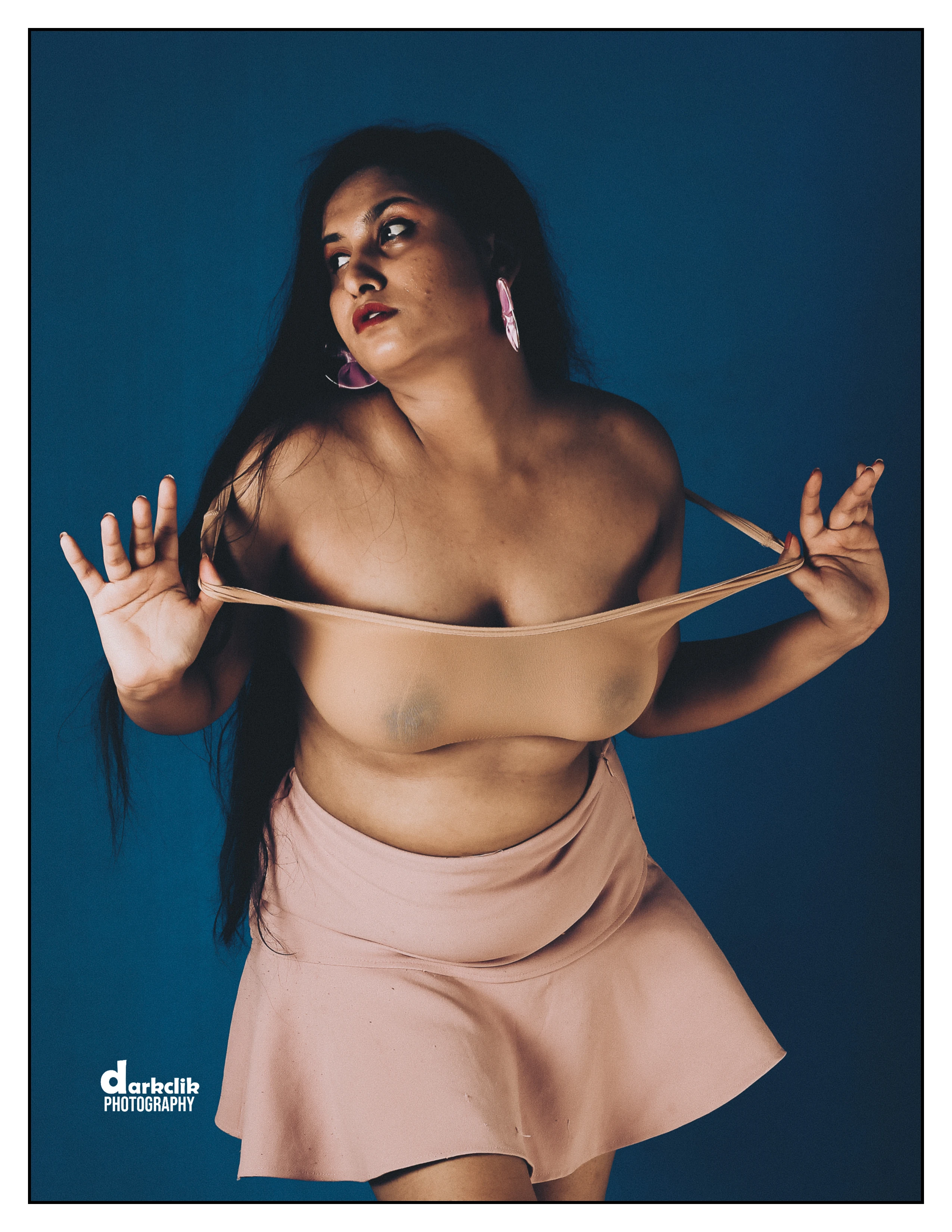 Desi MILF wearing a pink skirt and transparent tops showing her big boobs right through it