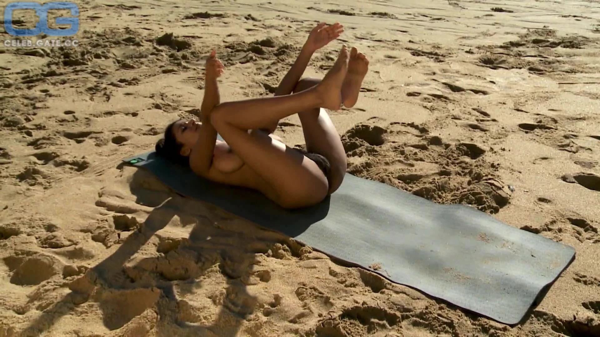 Nude Desi model doing yoga in beach showing her big boobs and hairy pussy