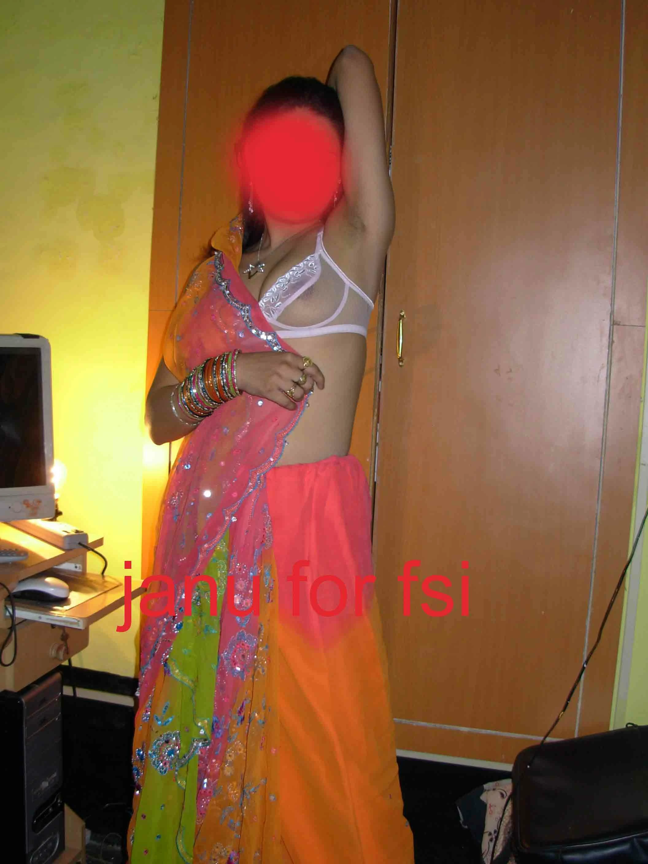 Desi wife showing her slim beauty and showing her petite boobs in a transparent bra while posing in an orange saree
