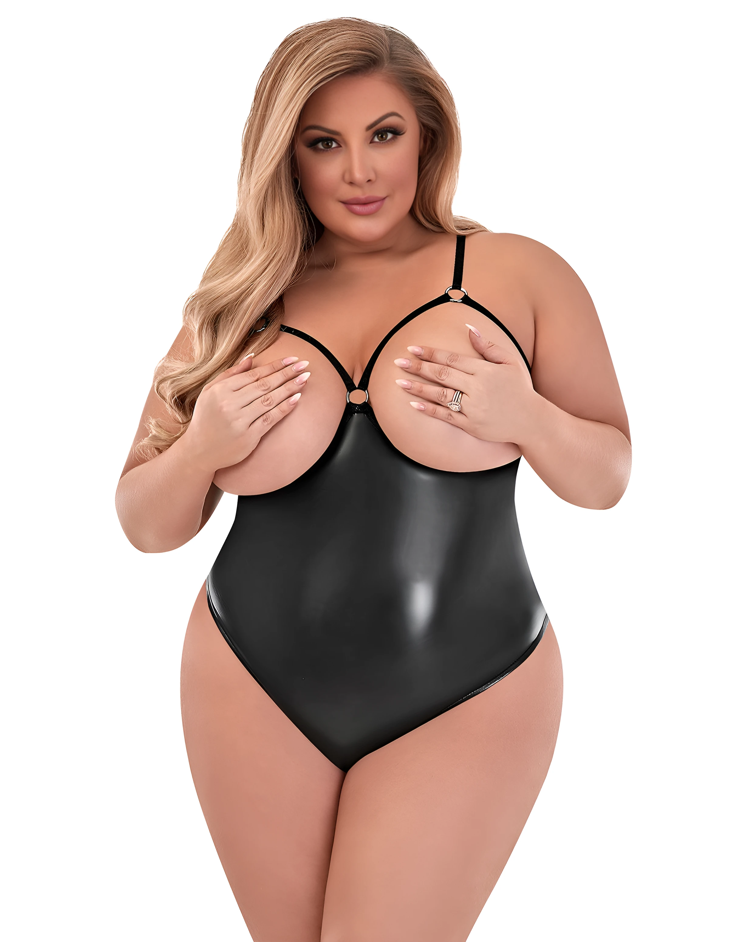 Voluptuous model wearing a matte onyx cupless and crotchless teddy and hiding her naked huge boobs with her hands