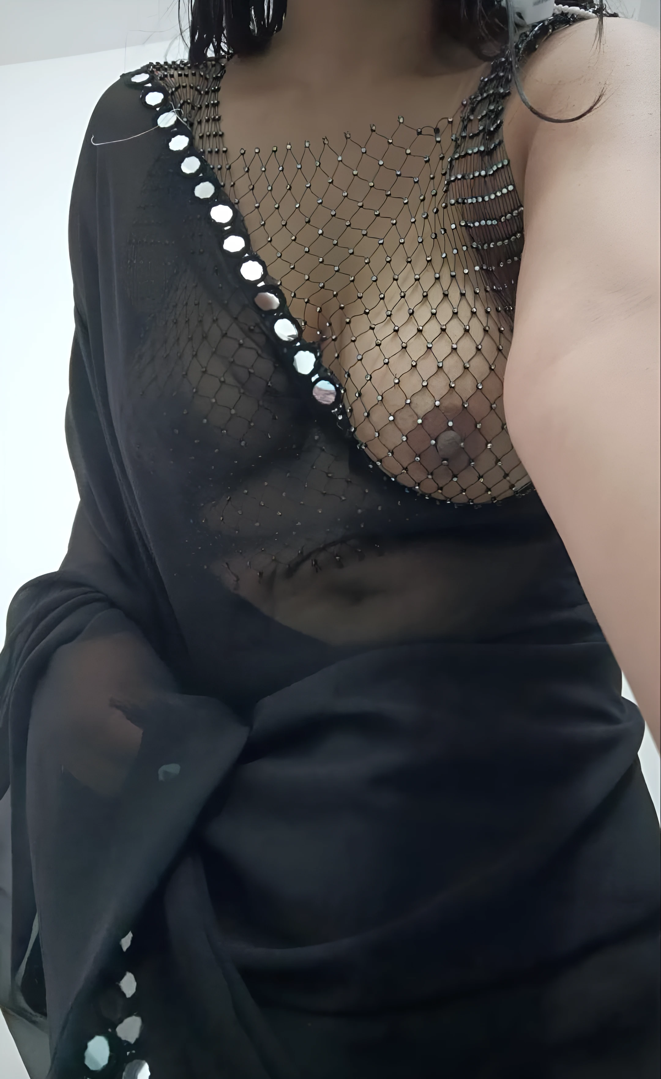Desi lady leaves you speechless with her boobs in a mesh shaped blouse and in a braless black saree