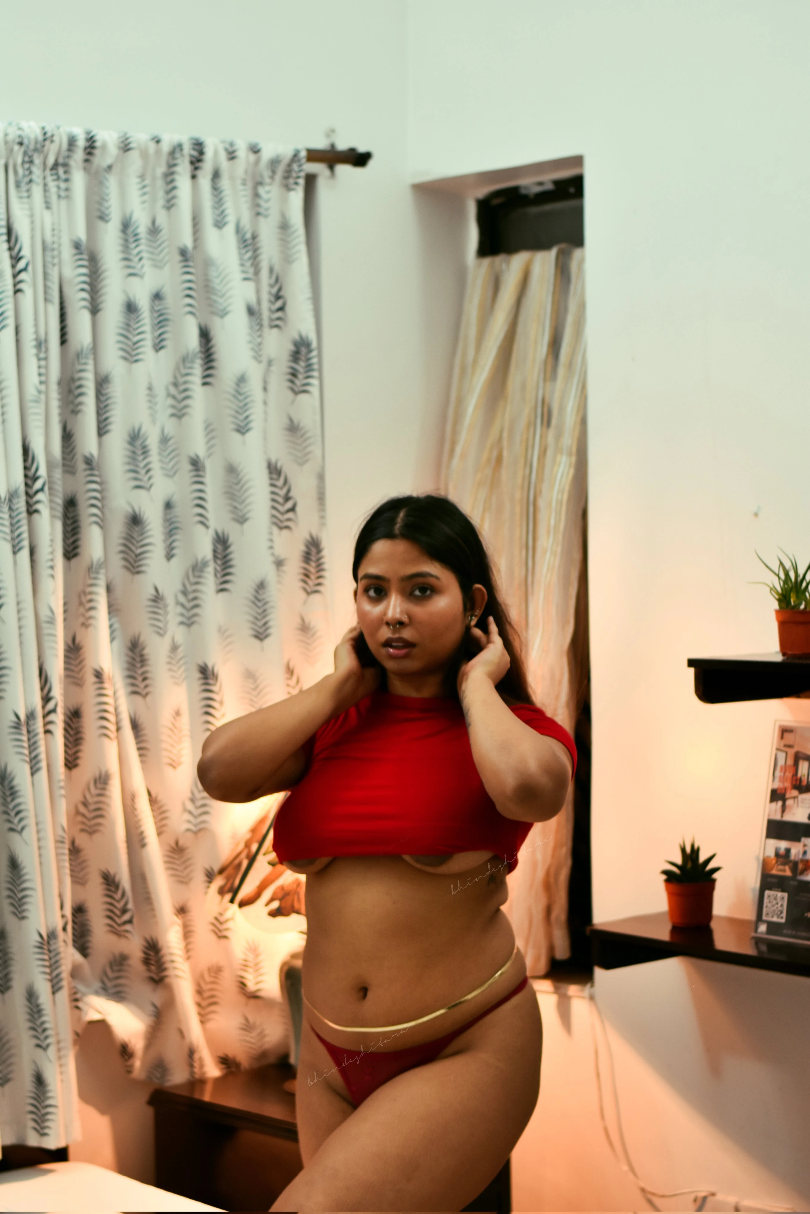 Desi MILF in a red tank top and skimpy panties and barely hiding her big boobs and showing her nipples partially