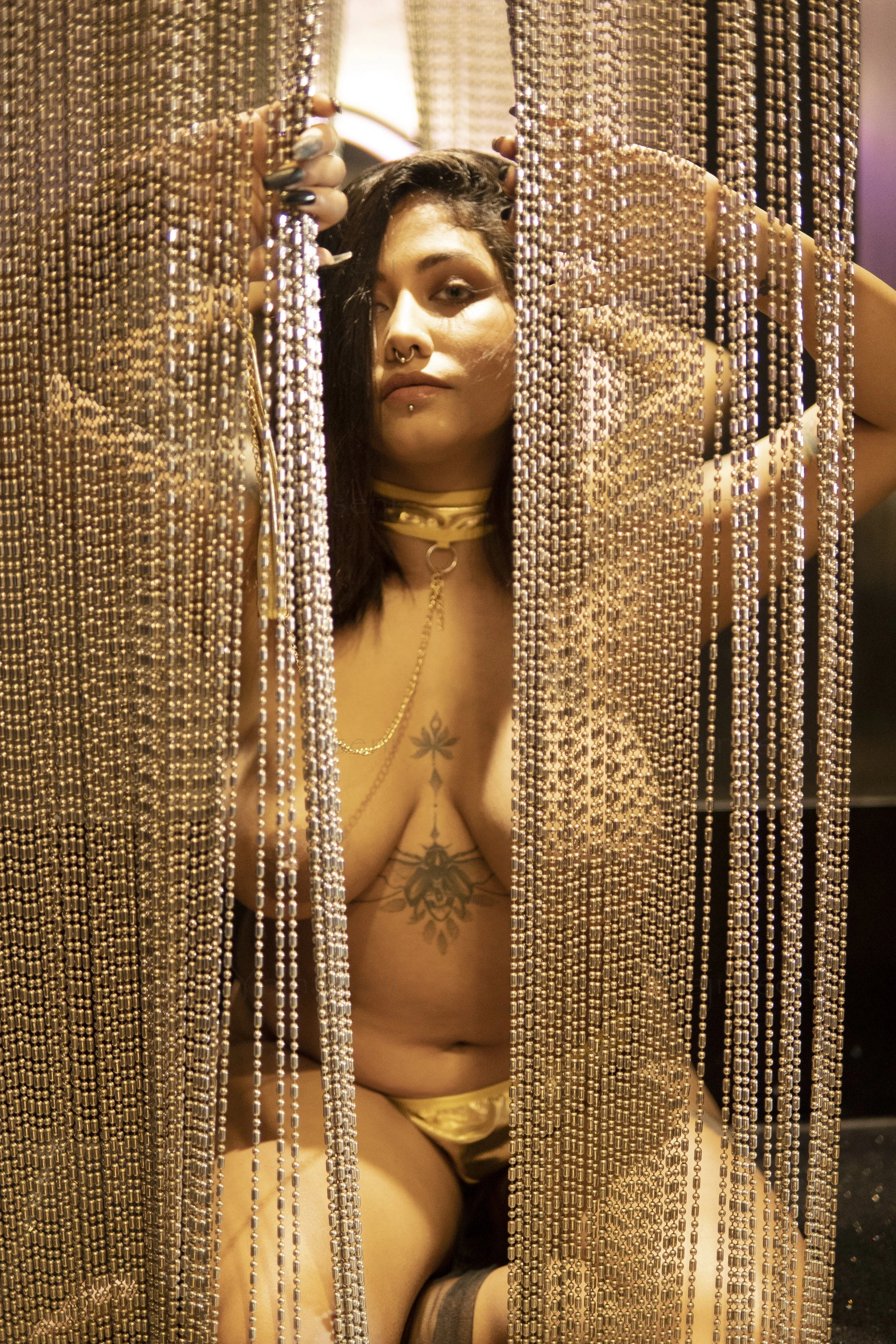 Busty Desi MILF behind beaded curtain and sensually hiding her big tits