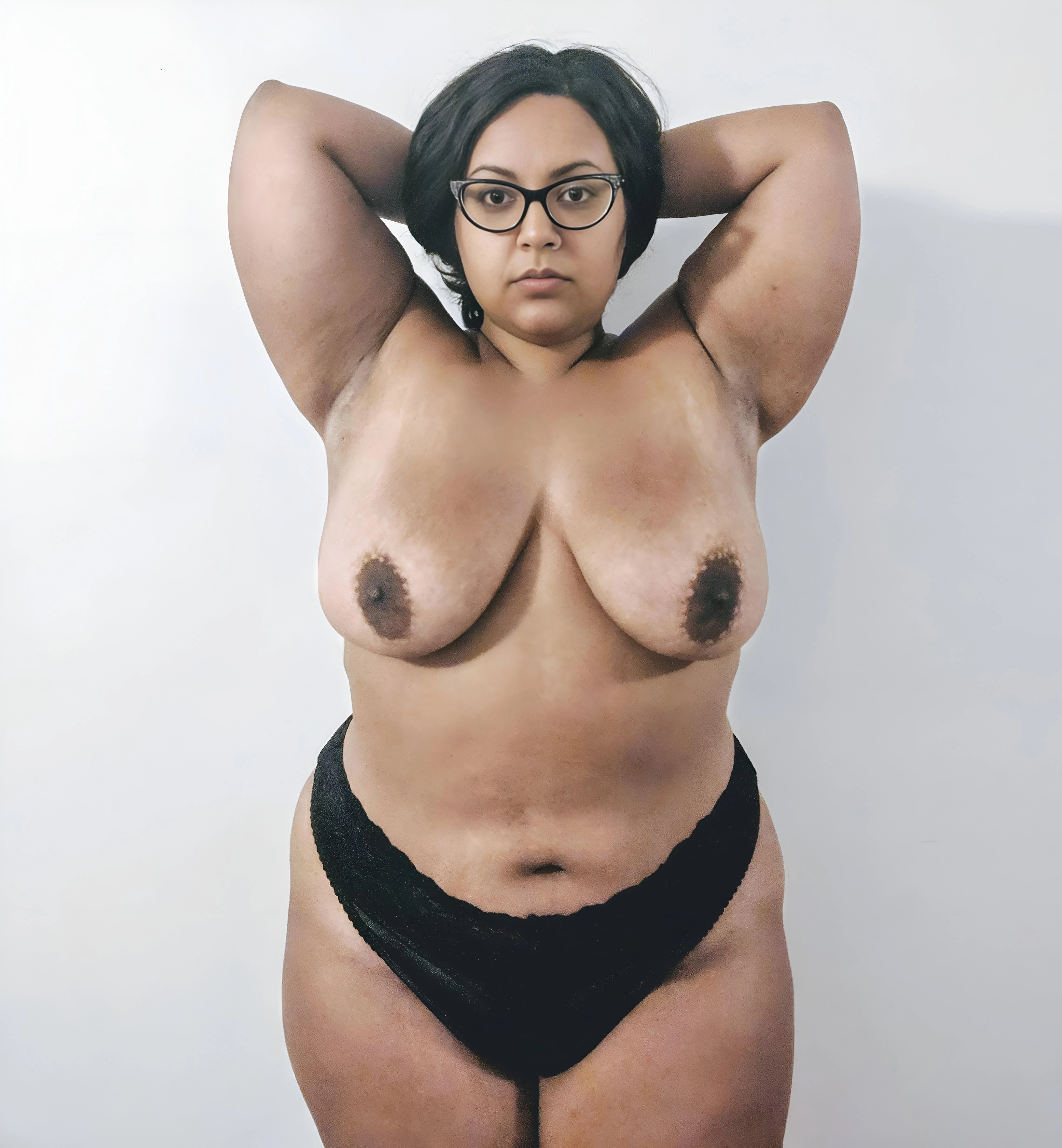 Desi MILF with large breasts with dark brown areolas and prominent erect nipples while wearing black lace underwear