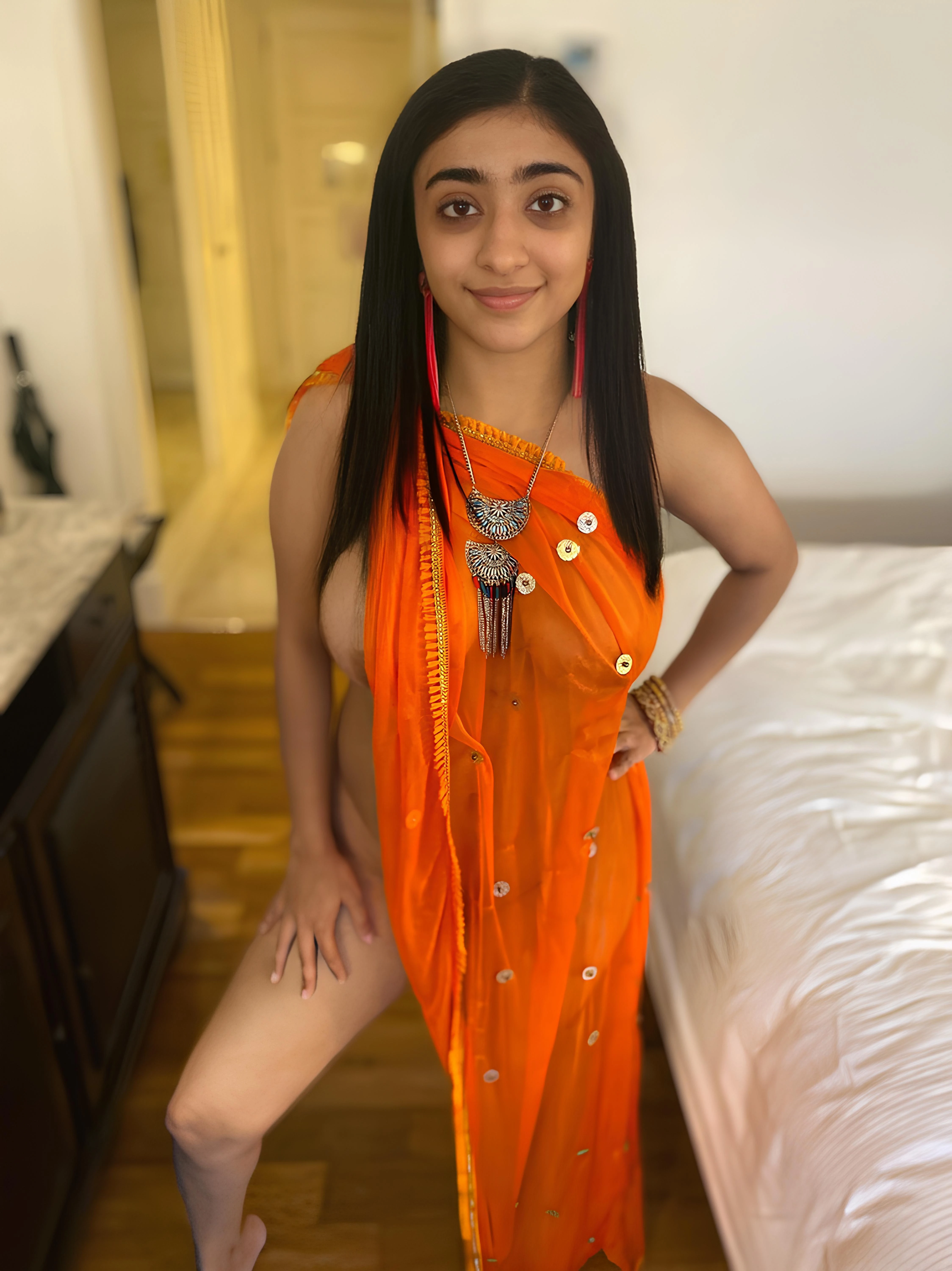 Totally naked Baby Misaka in a sheer orange sari displaying her bare breasts and smooth shaved pussy