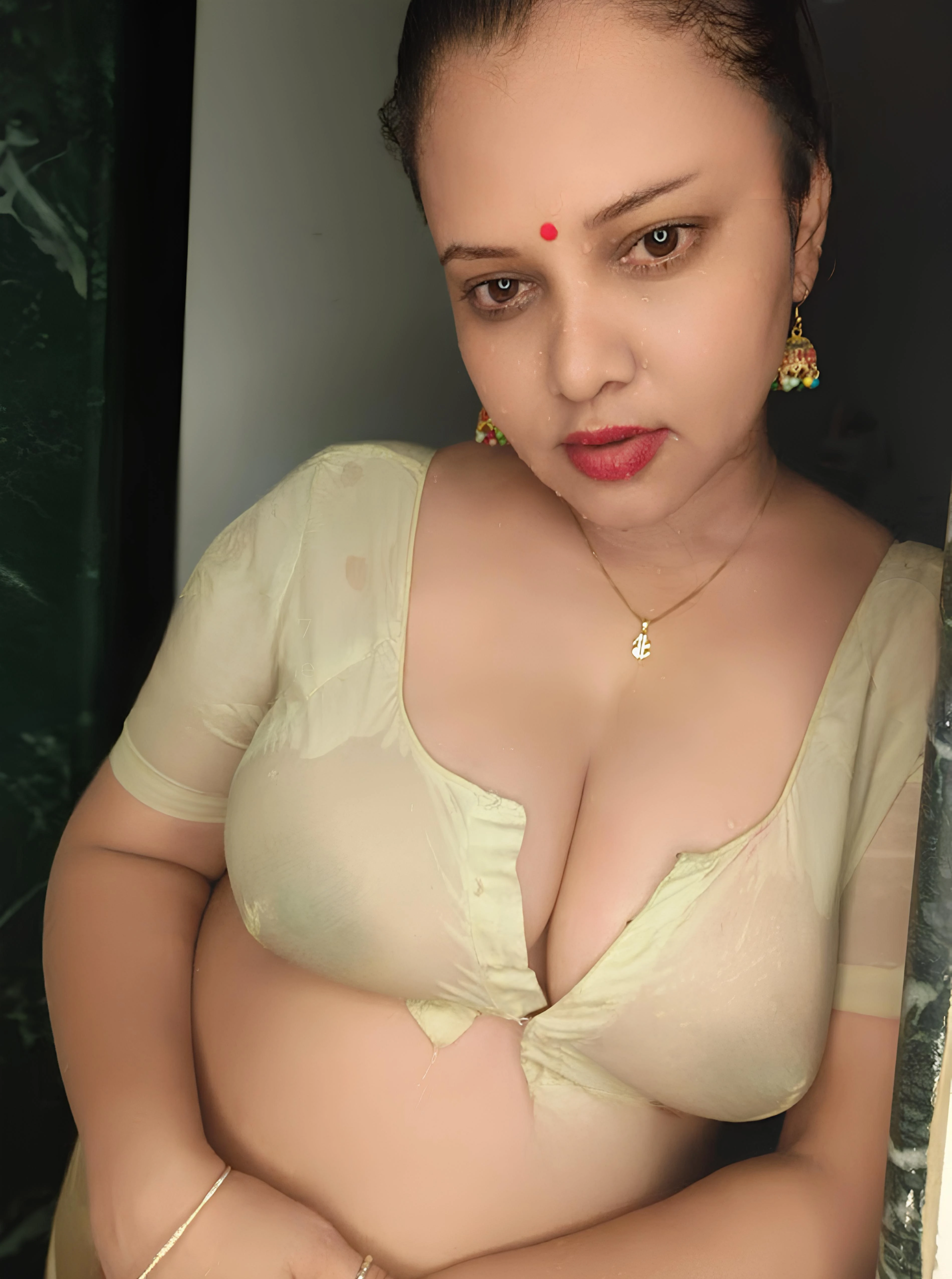Sexy Priya Gamre showing bare heavy breasts through a sheer yellow wet blouse