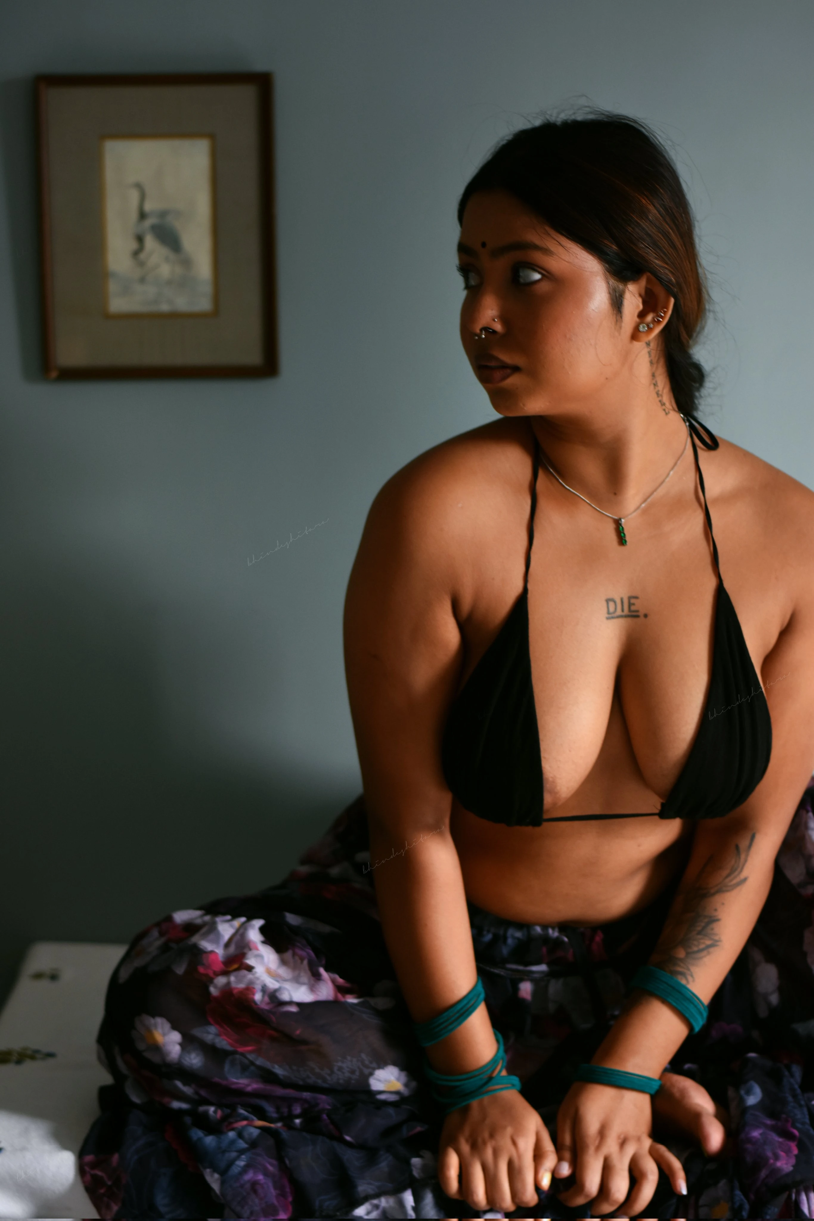 Desi model Bhindeshitara in a vibrant floral skirt showing her nipples peeking out of a black halter top