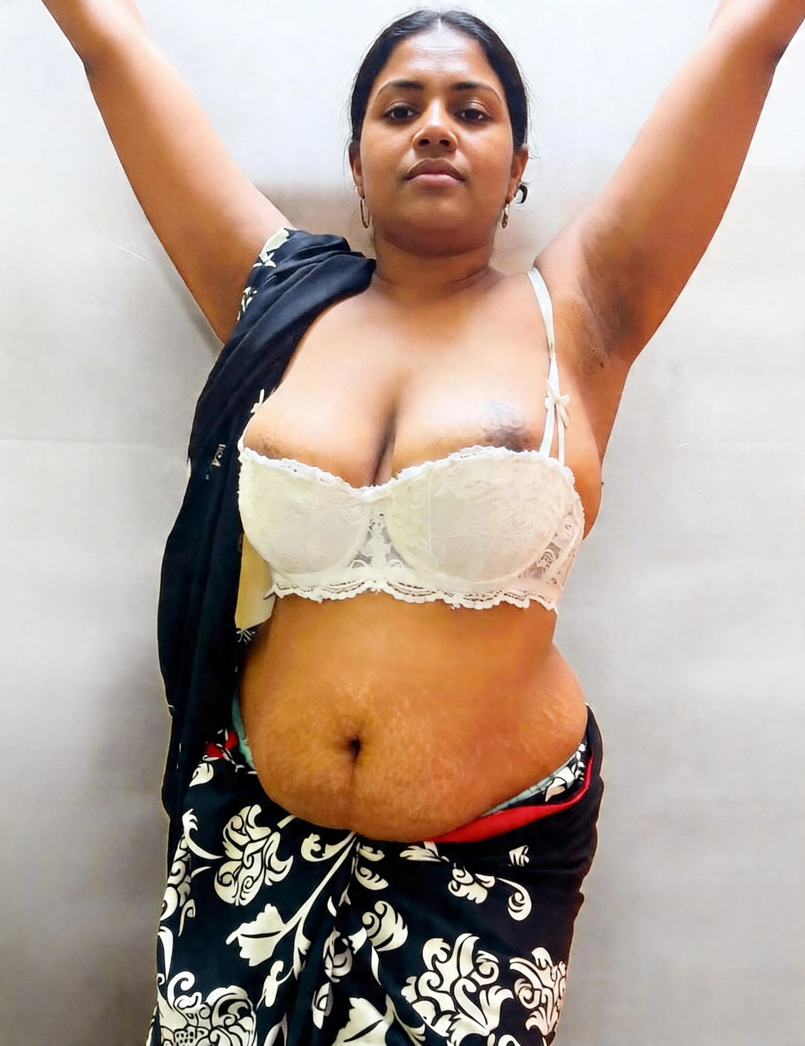 Desi woman with prominent dark areolas and large breasts in white lace bralette with dark fabric draped over shoulder