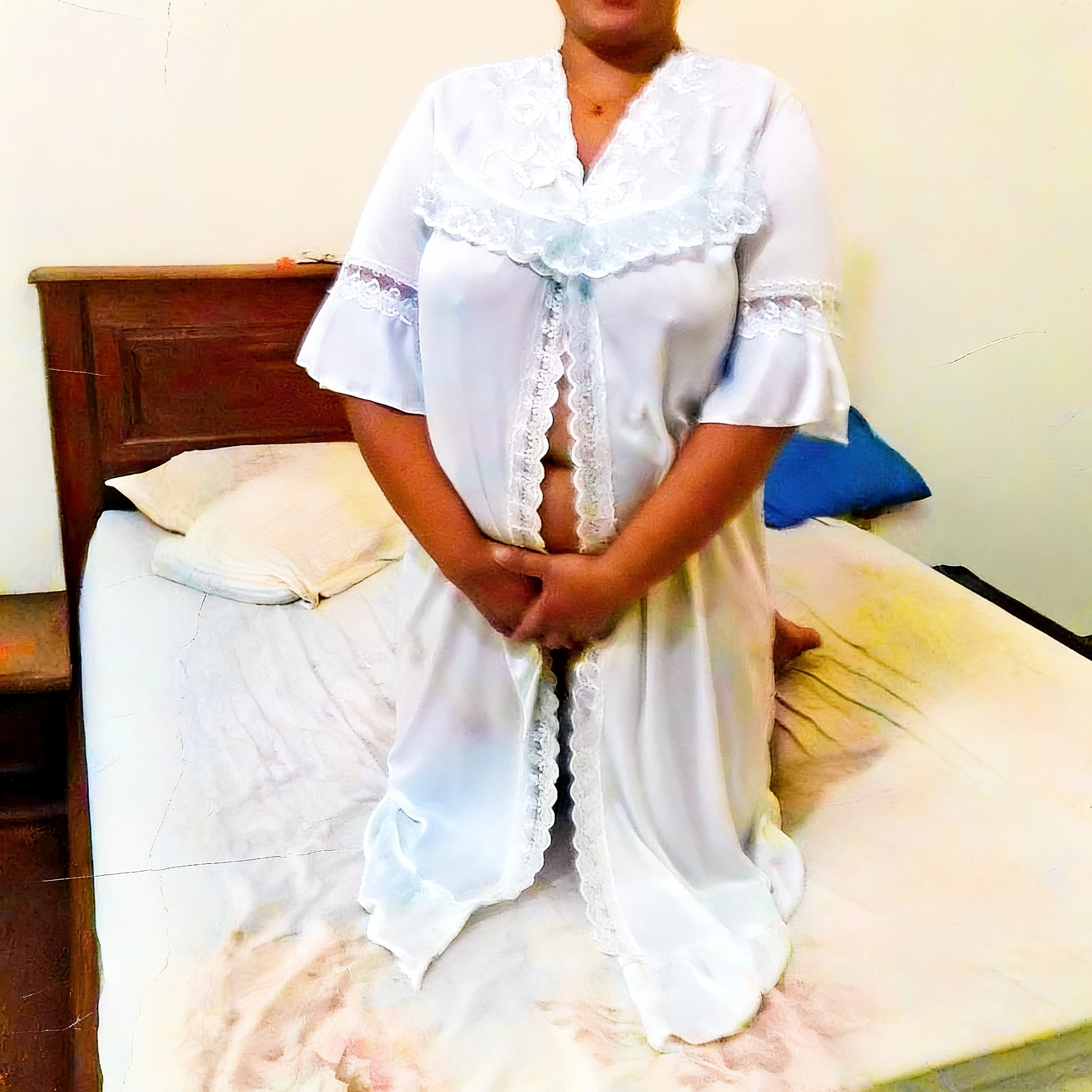 Desi lady kneeling on bed and showing her boobs through a sheer white lace nightgown with open front and lace trim
